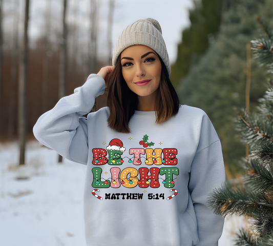 BE THE LIGHT FESTIVE HOLIDAY SWEATSHIRT